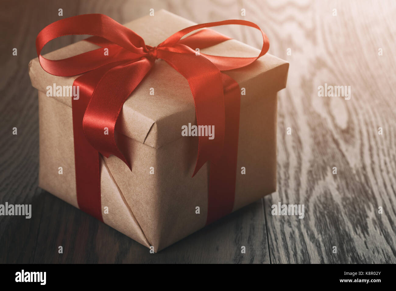 rustic gift box with red ribbon bow Stock Photo