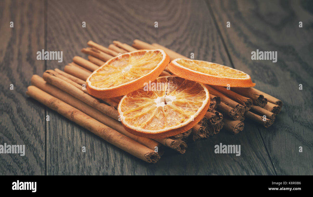 true cinnamon sticks and dried oranges Stock Photo