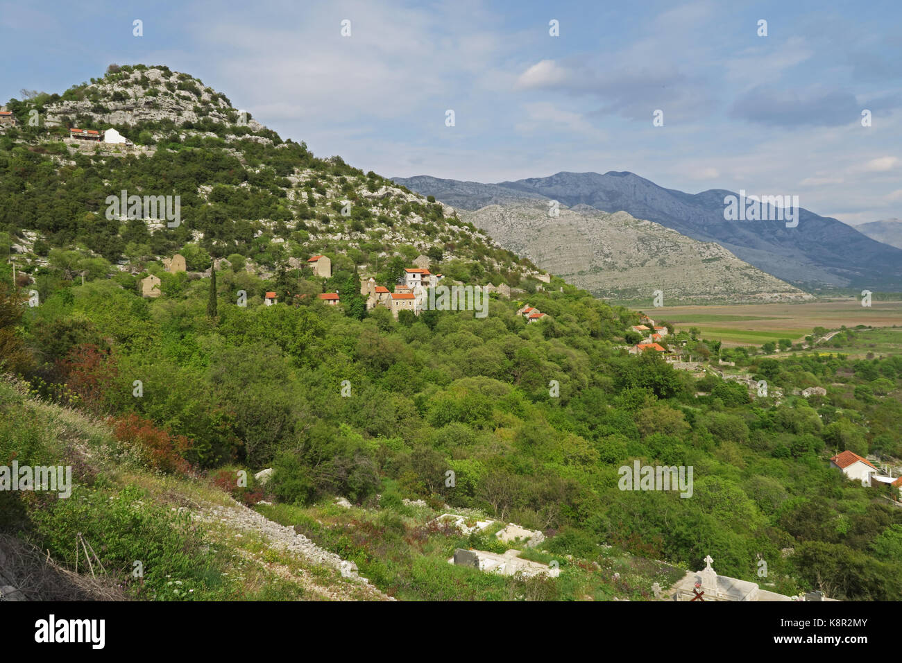 view of hillside village above karst field  Popovo Polje karst field, Herzegovina, Bosnia and Herzegovina      April Stock Photo