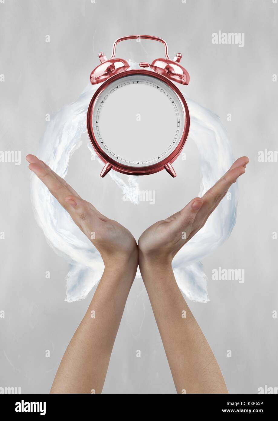 Digital composite of Business woman holding a clock against background with clock Stock Photo