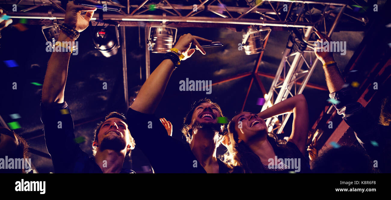 Flying Colours Against Friends Photographing At Concert Stock Photo Alamy