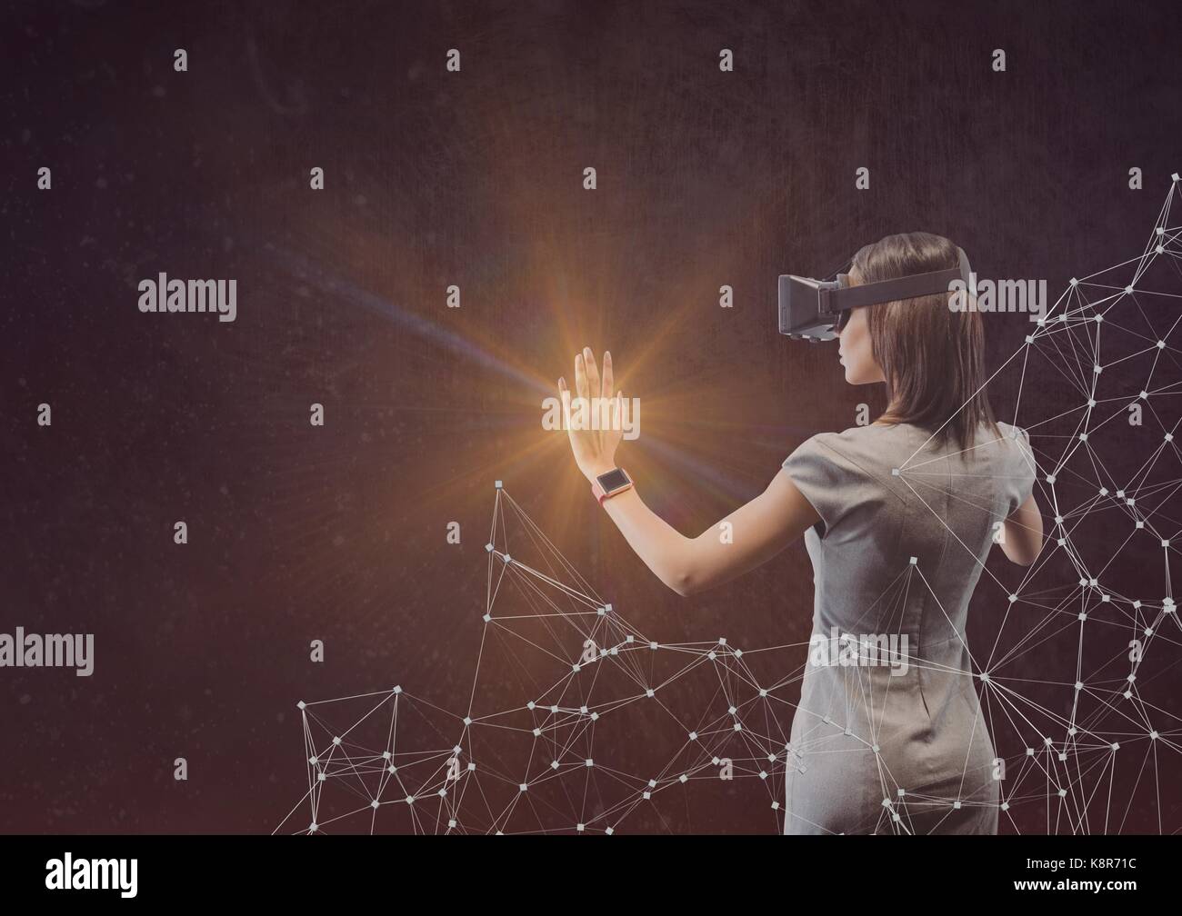 Digital composite of woman in dress with vr touching light Stock Photo ...