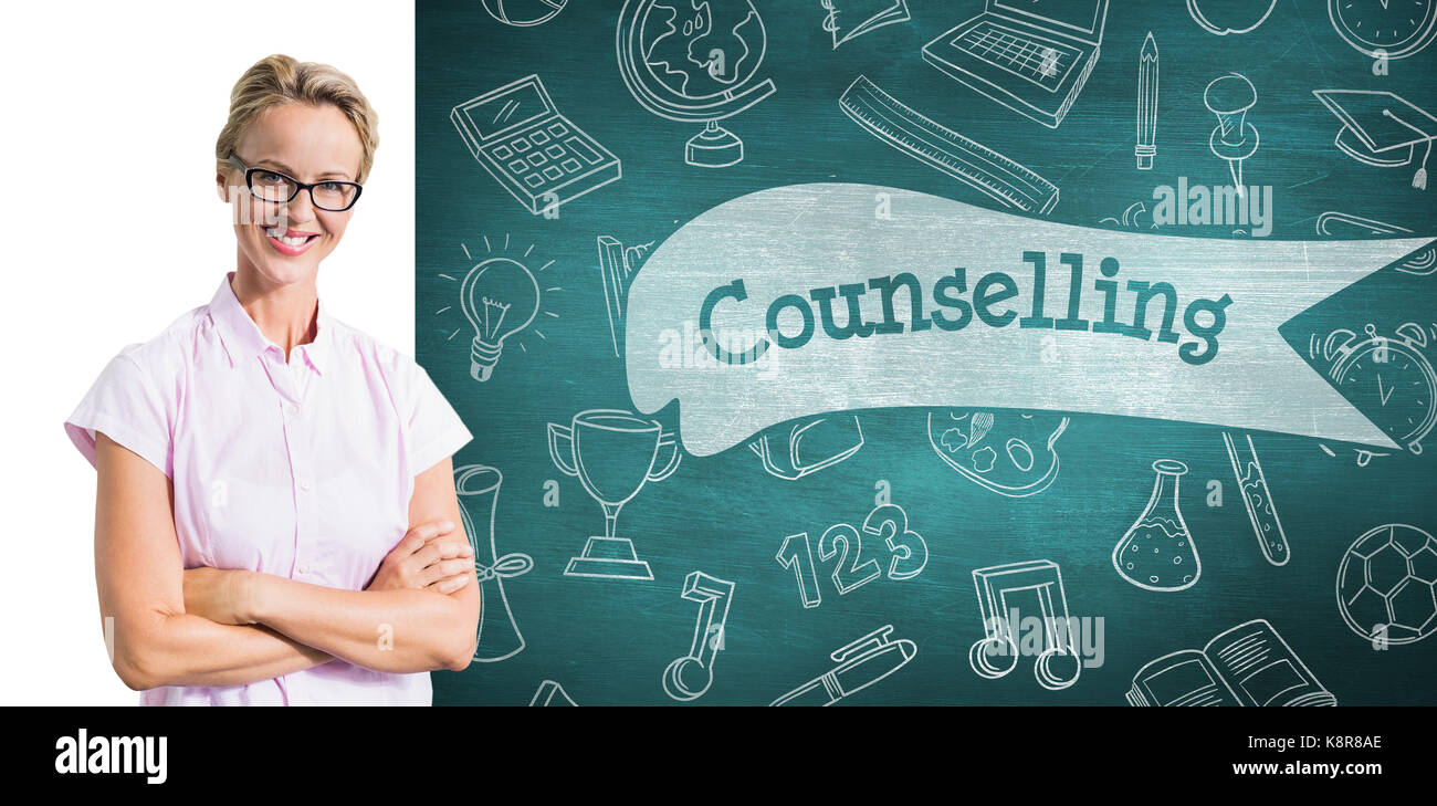 Portrait of smiling teacher against counselling against green chalkboard Stock Photo