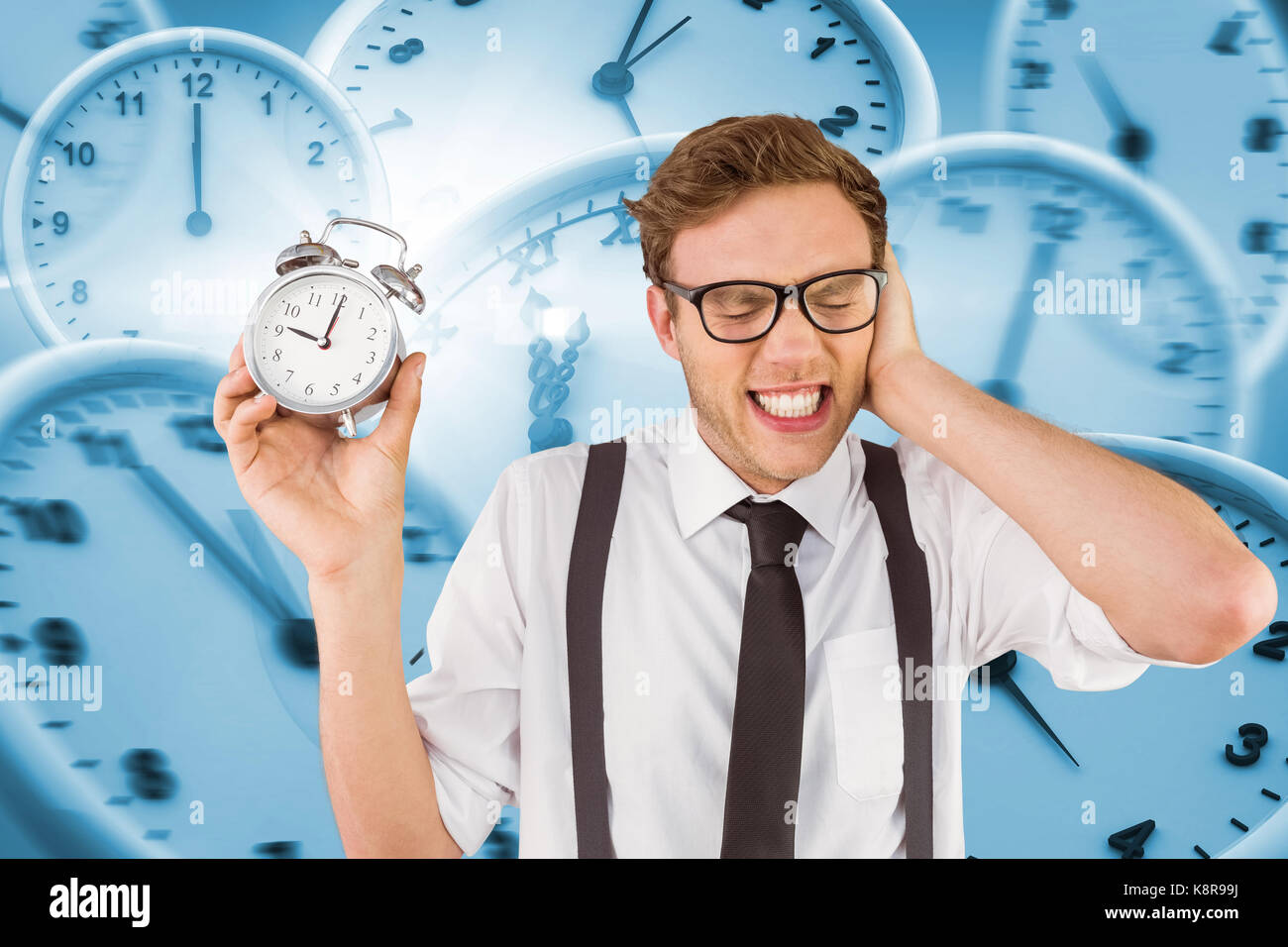 Geeky businessman holding alarm clock against digital image of wall