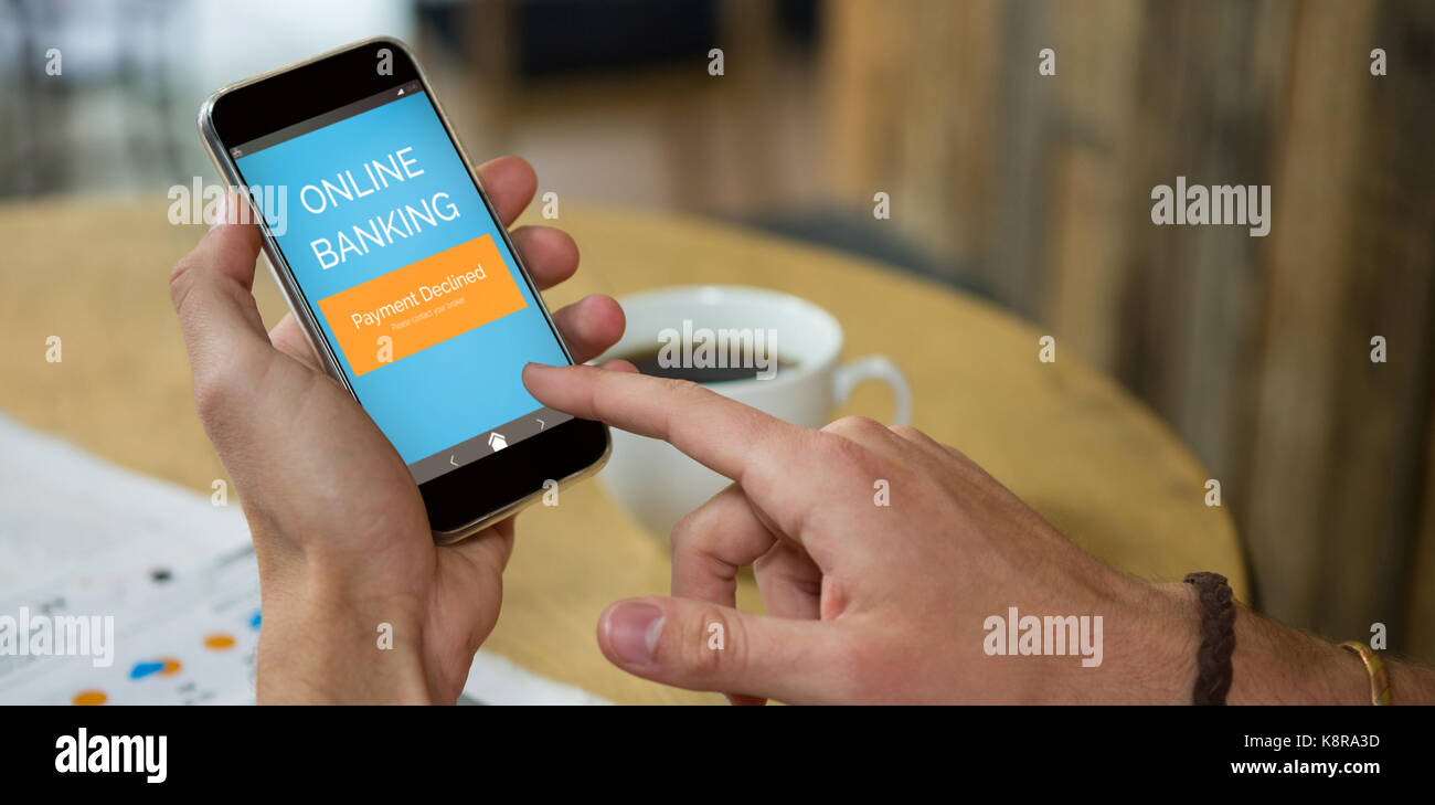 Online banking text on green mobile display against man using mobile ...