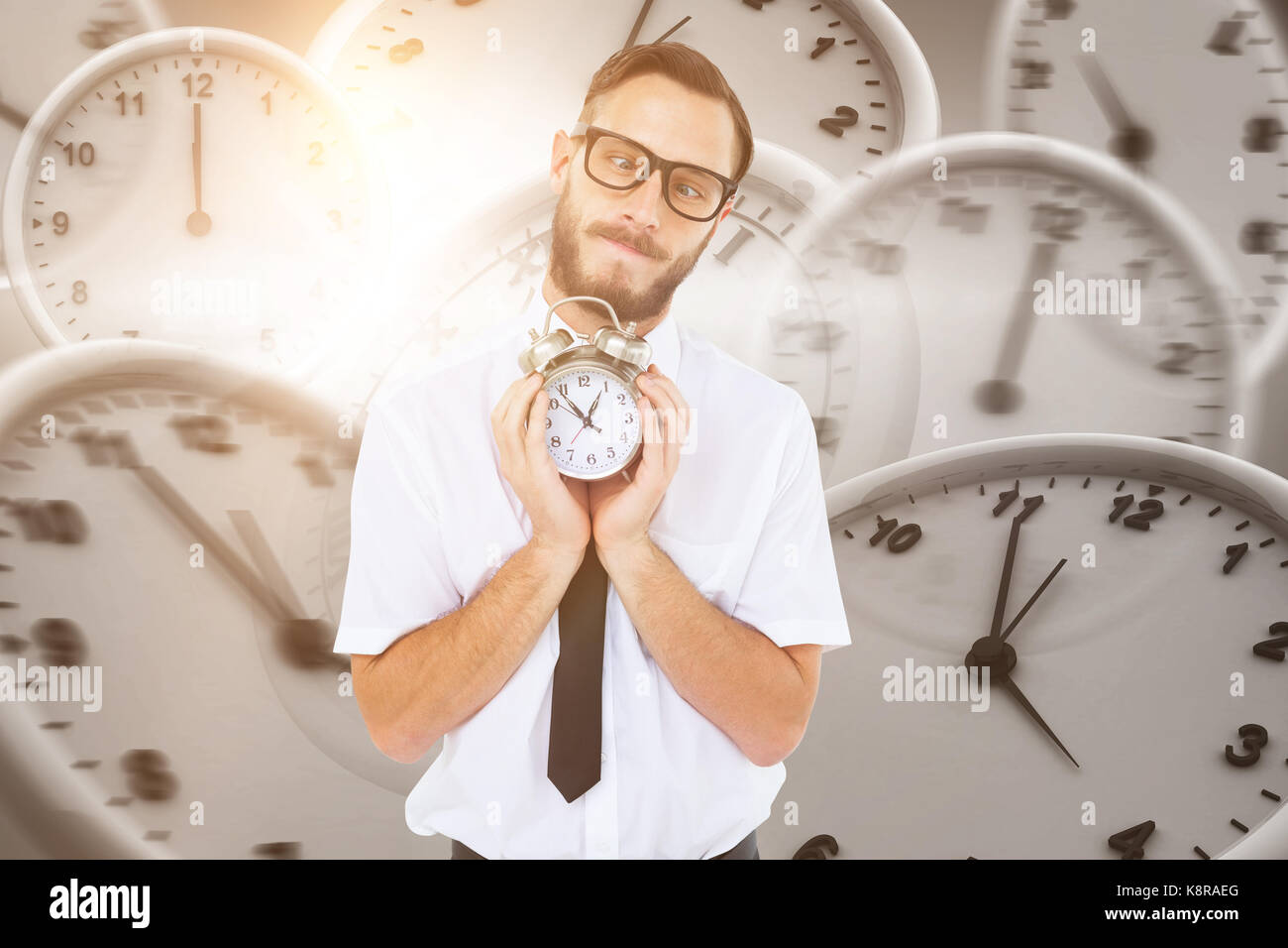 Geeky businessman holding alarm clock against digital image of wall