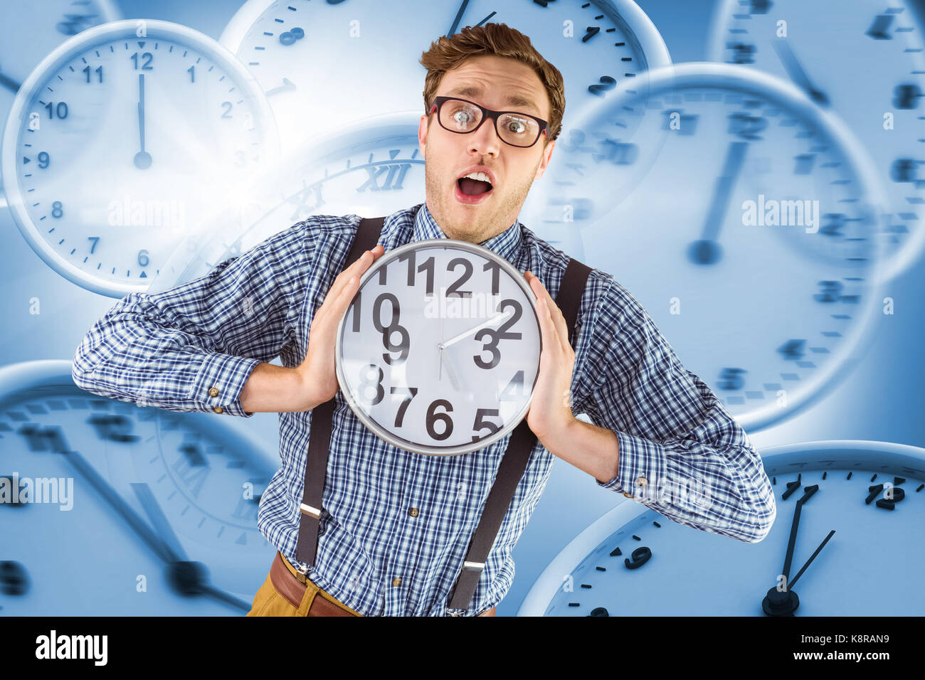 Geeky businessman holding a clock against computer generated image of ...