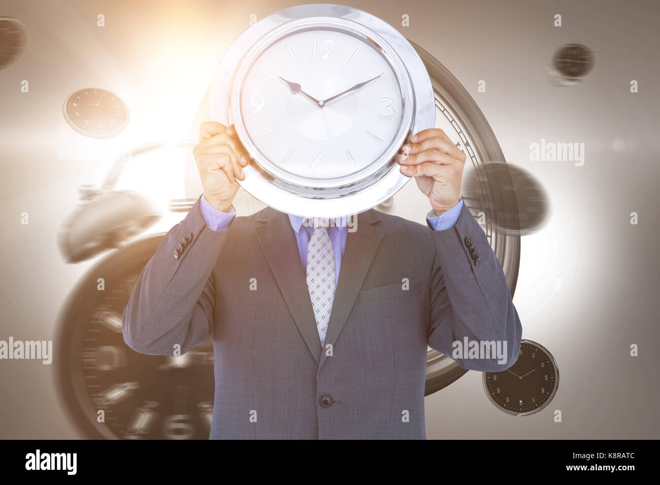 Businessman holding wall clock in front of face against digital image
