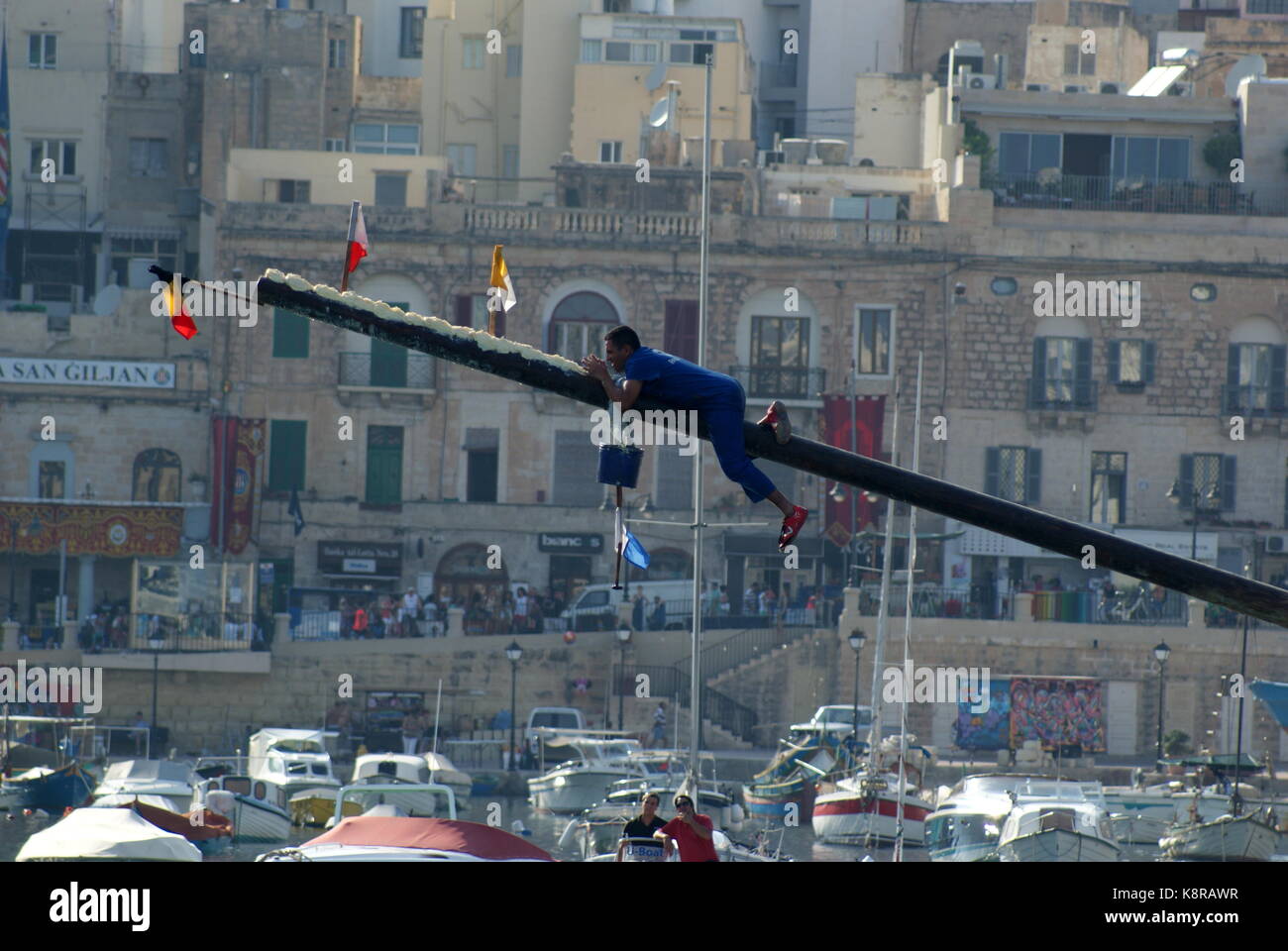 Greasing the greasy pole at the Feast of St Julian celebration, St Julians Bay, Malta Stock Photo