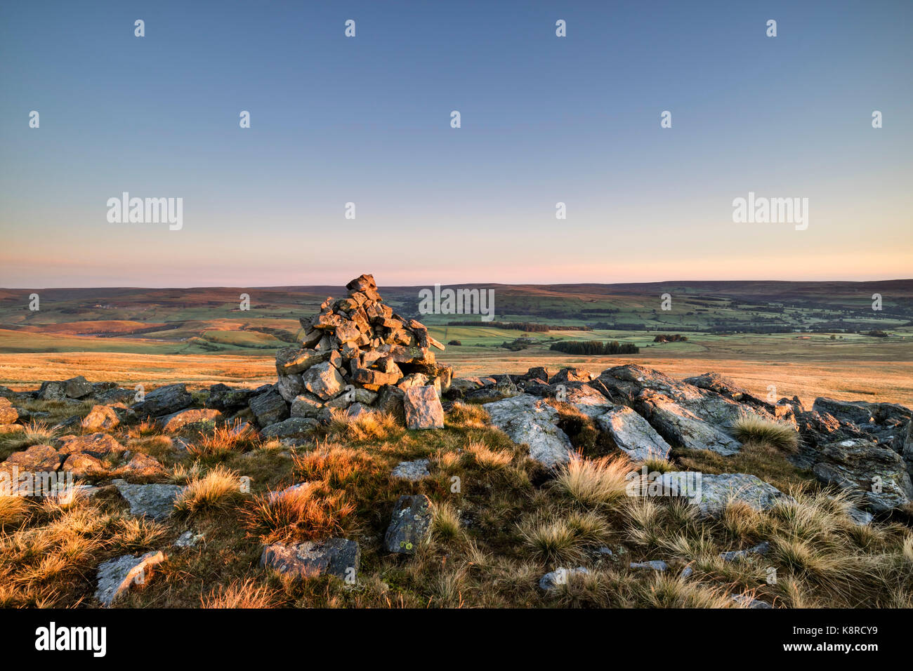 Early Morning Light Illuminating the Cairn on the Eastern End of Carrs Top (Bollihope Carrs), Weardale, County Durham, UK Stock Photo