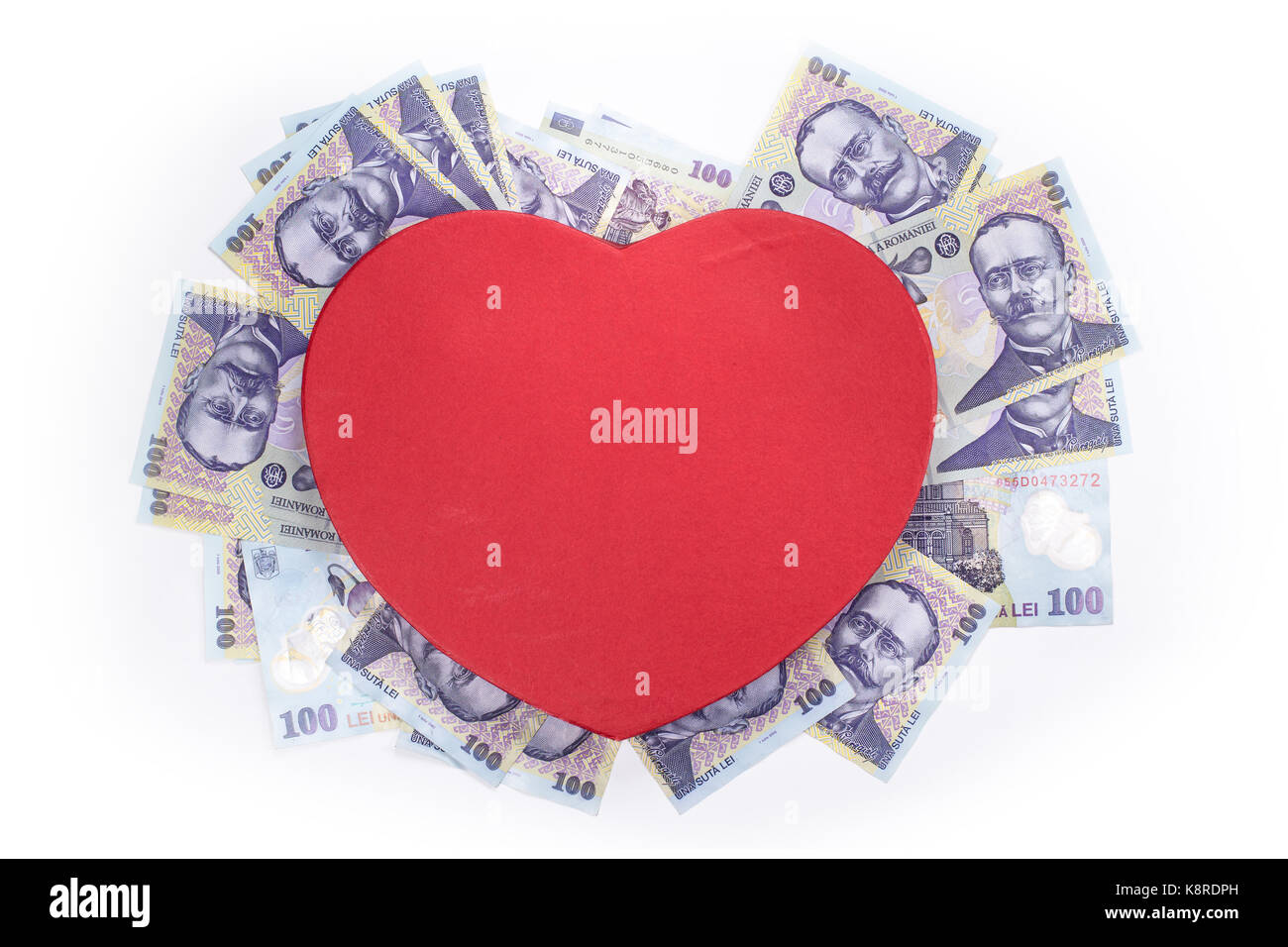Love for money concept. Conceptual image with a heart and romanian currency isolated on white background. Space for text, top view. Stock Photo