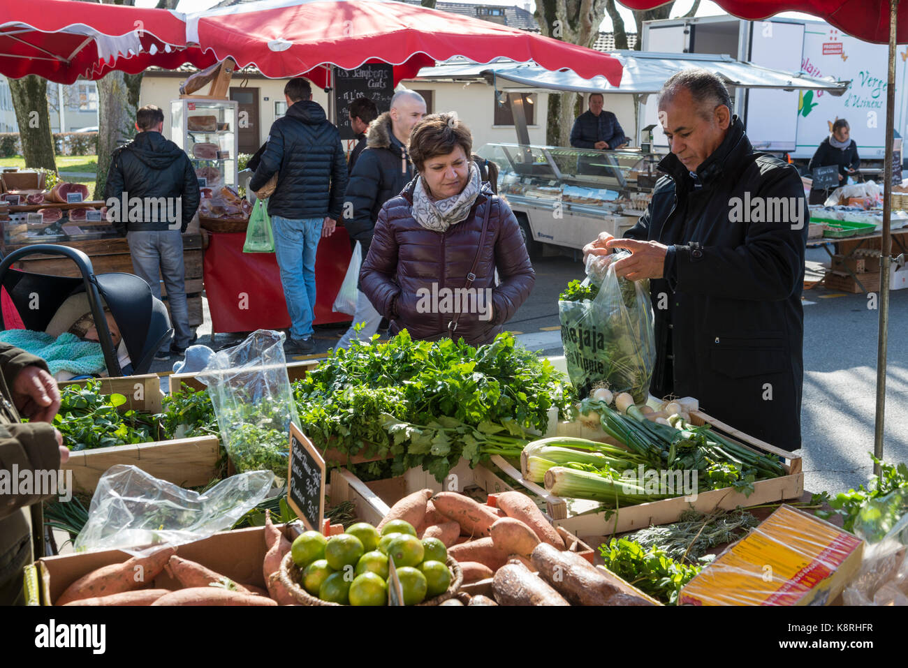 Woman buys vegetables, market in Ferney Voltaire, Ain Rhone-Alpes, France Stock Photo