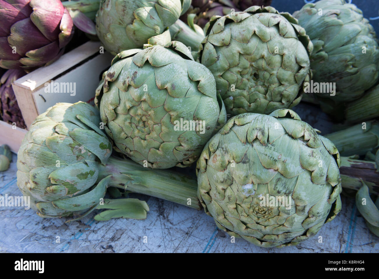 Artichokes on a market stall, Ferney Voltaire, Ain Rhone-Alpes, France Stock Photo