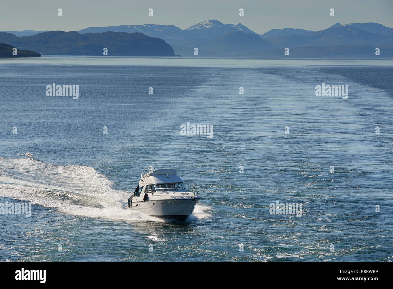 Speeding Sports Boat Travels Along Kaldfjorden, Troms County, Norway. Stock Photo