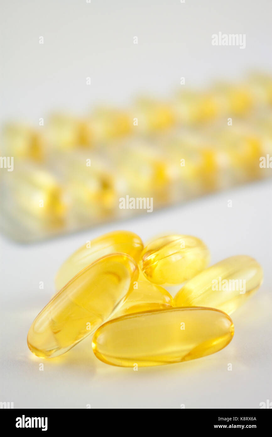 Yellow gel pills in a blister and unpacked Stock Photo Alamy