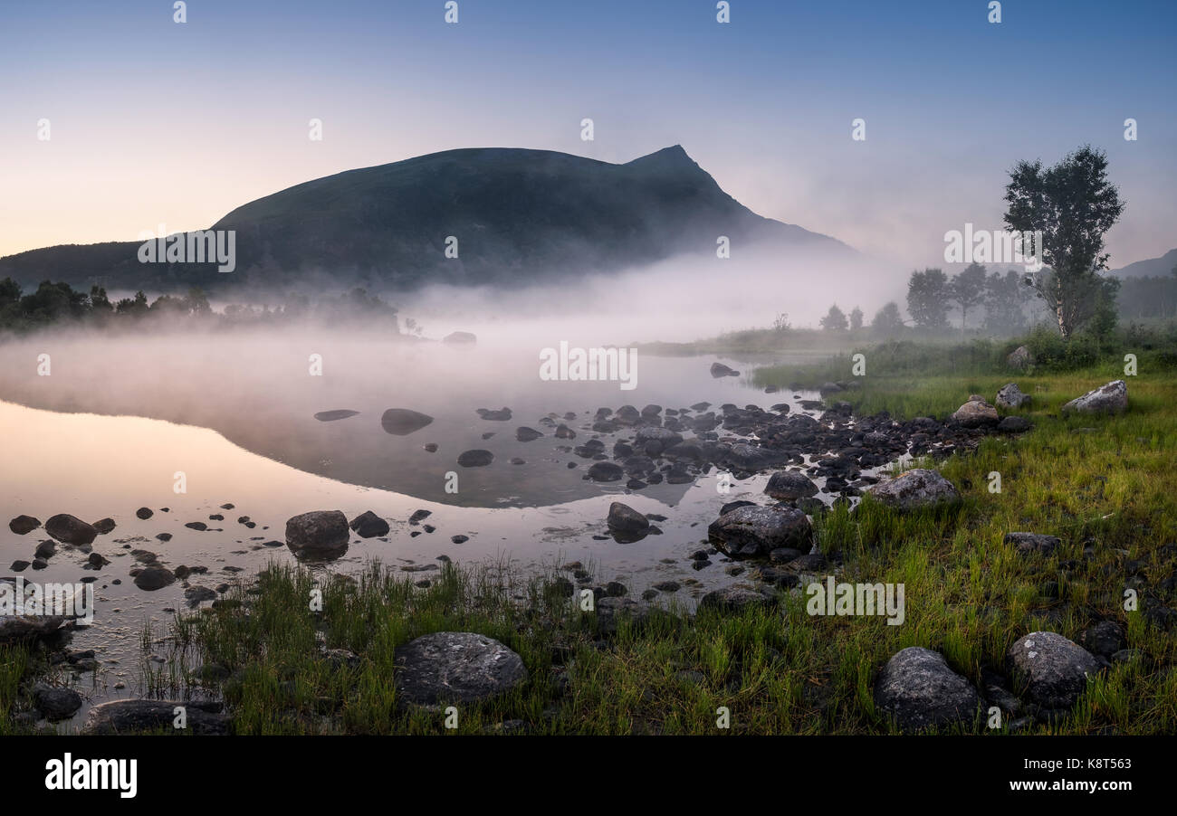 Scenic view with lake and fog at summer night in Lofoten, Norway Stock Photo