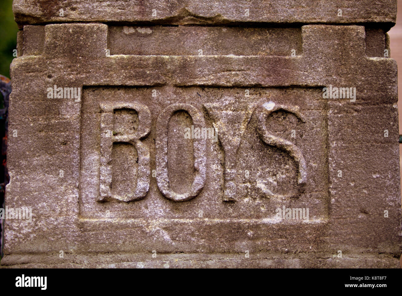 stone carved old vintage school gender signs boys Stock Photo