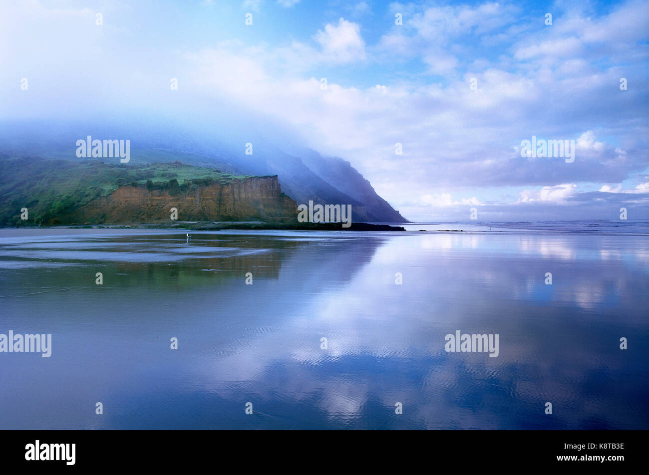 New Zealand. North Island. Low level cloud over west coast cliffs and beach. Stock Photo