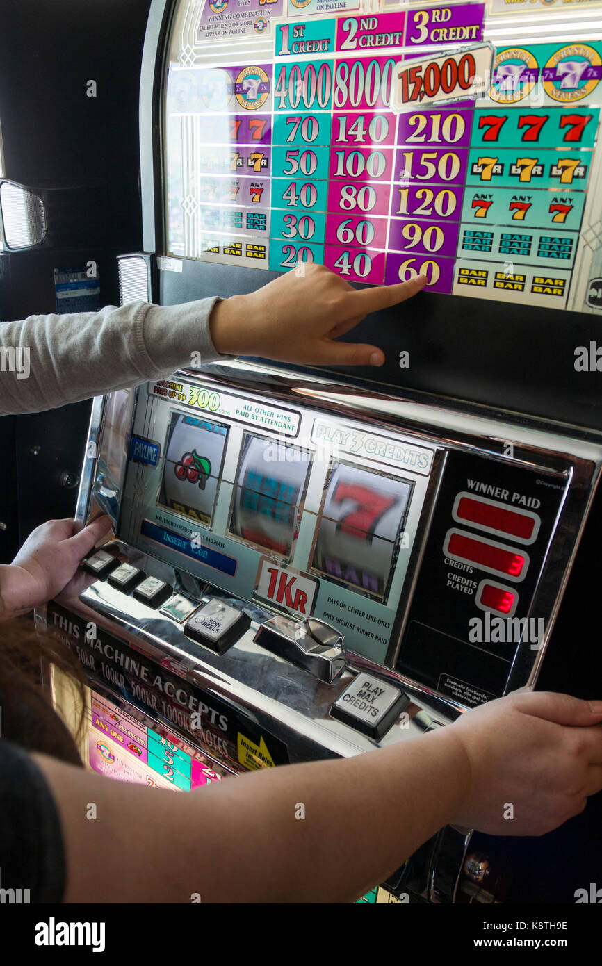 Unrecognizable people or person playing on coin slot machine  Model Release: No Property Release: No Stock Photo