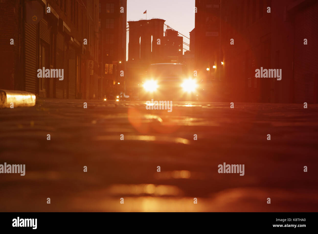 Lens flare car headlights under the Manhattan and Brooklyn Bridge at