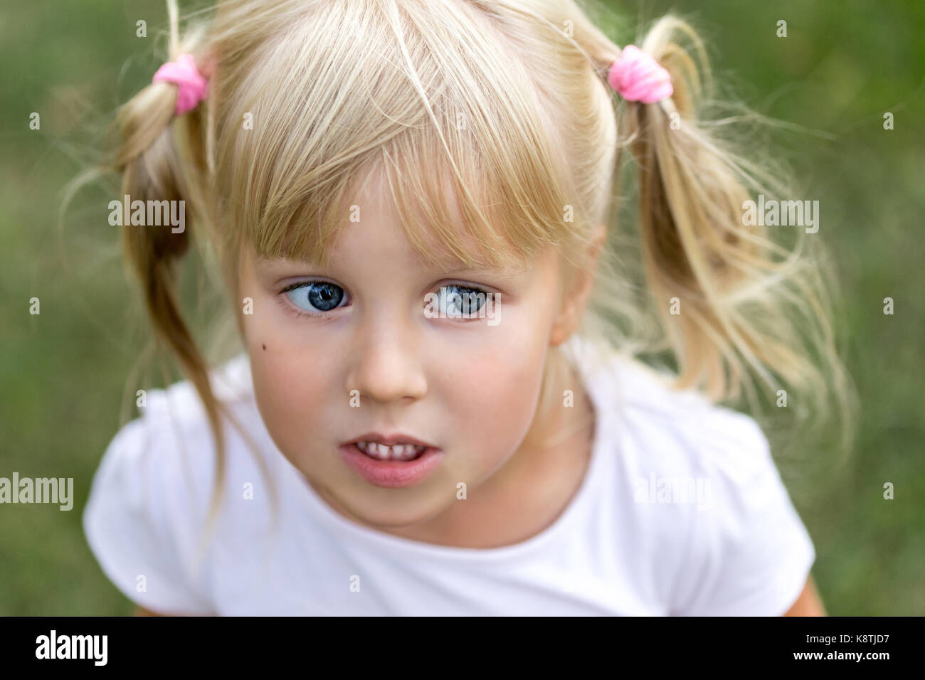 Close up portrait of cute adorable little blonde caucasian girl in a ...