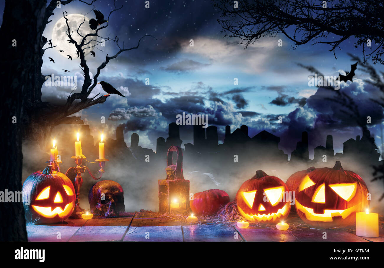 Spooky halloween pumpkins on wooden planks with dark horror background ...