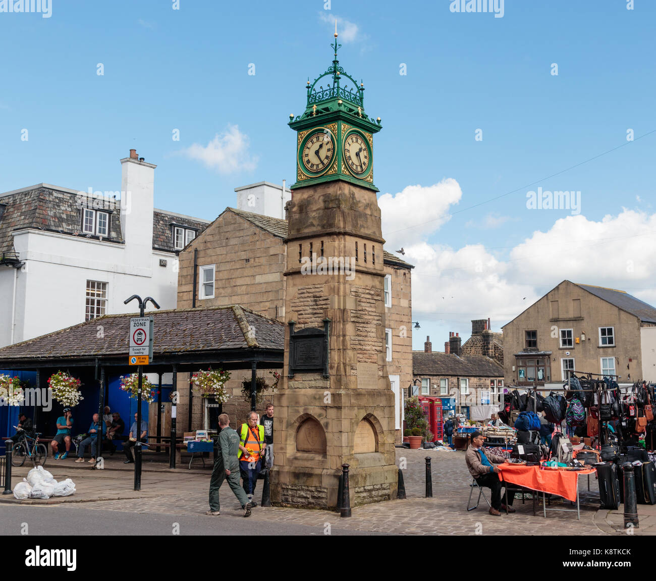 Unidentified people shopping in Otley outdoor market, next to the Jubilee clock tower Stock Photo