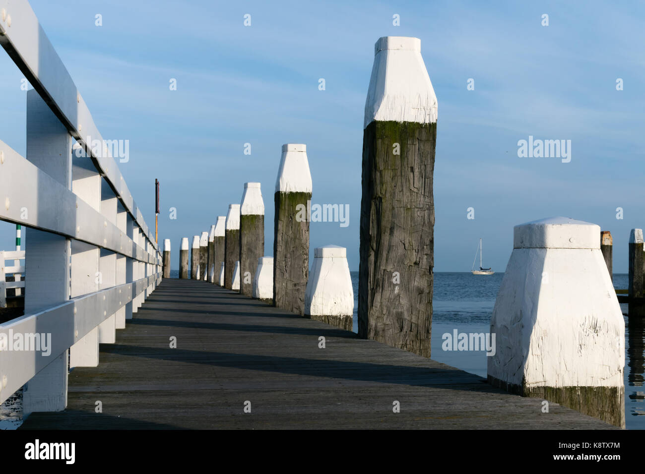 nice wooden pier on the isle of Vlieland in Holland on a sunny day Stock Photo