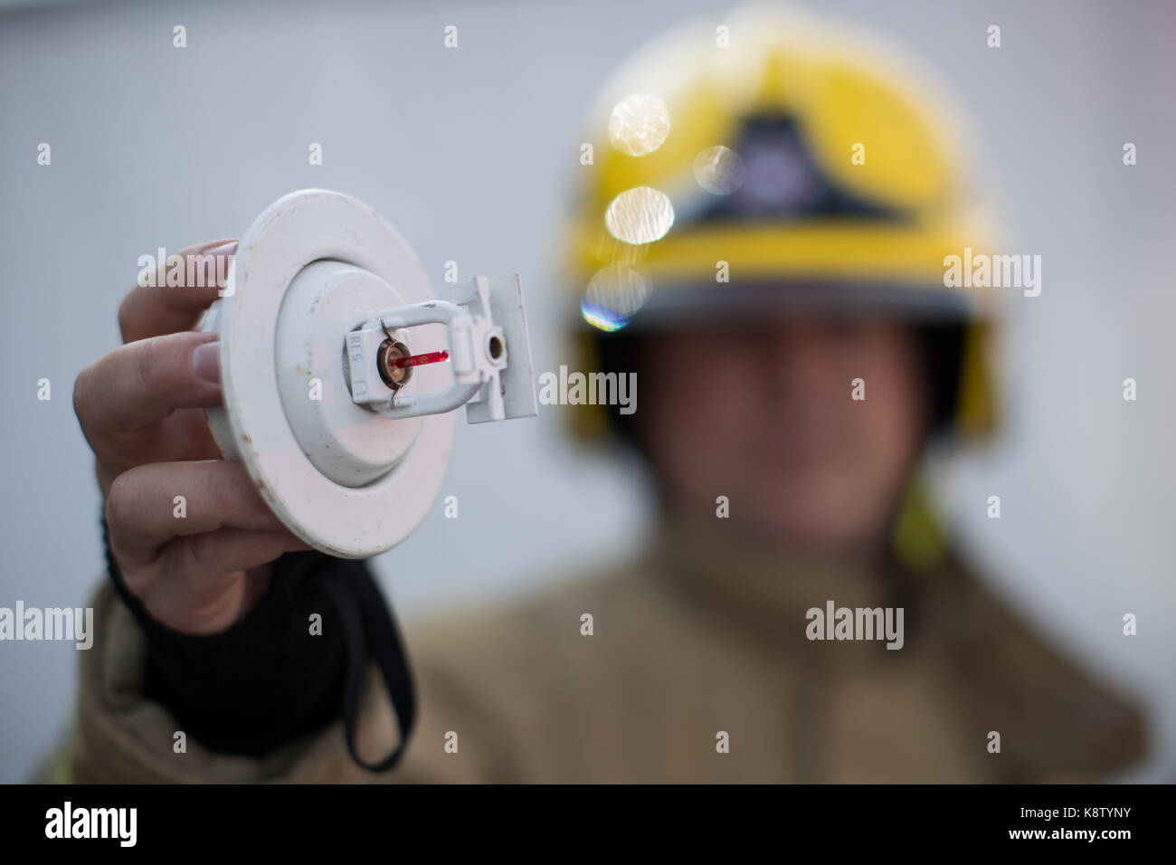 Steve Rescoe, Technical Fire Safety Officer holds up a sprinkler during
