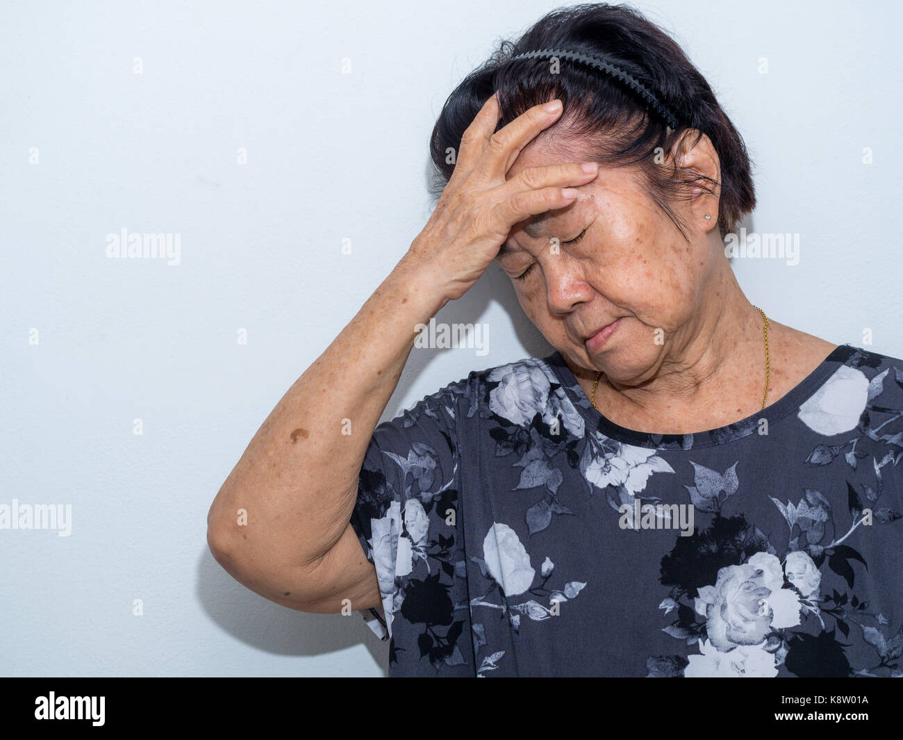 Old Senior Woman Suffering And Covering Face With Hands In Headache And ...