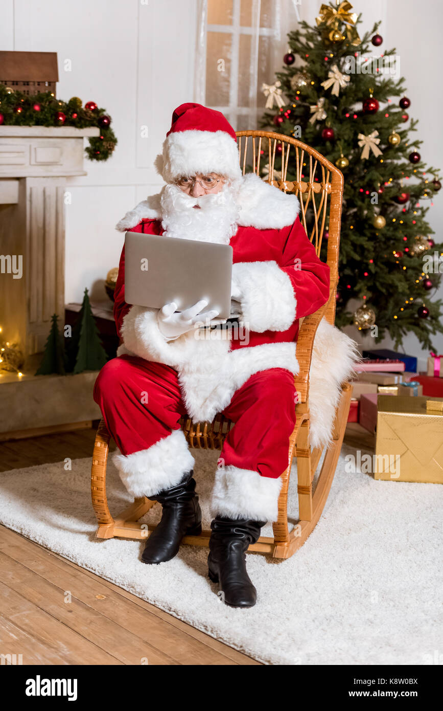 santa claus typing on laptop Stock Photo