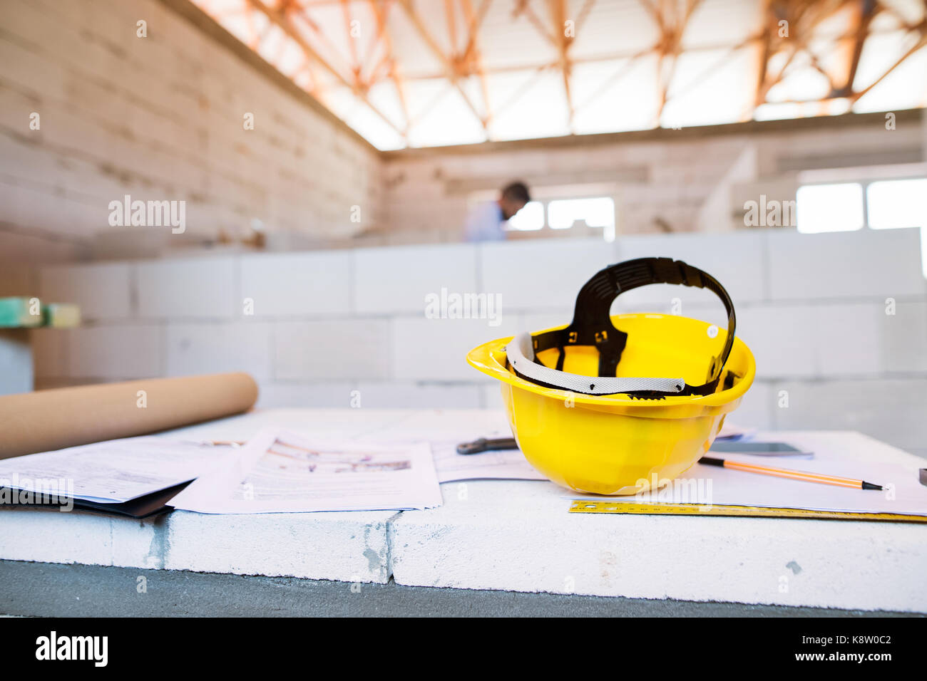 Helmet and blueprints on construction site Stock Photo - Alamy