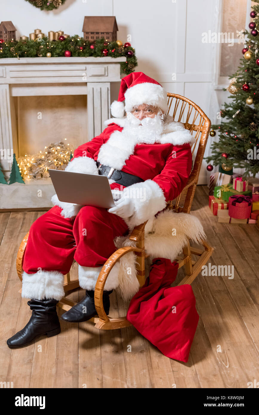 santa claus with laptop at home Stock Photo
