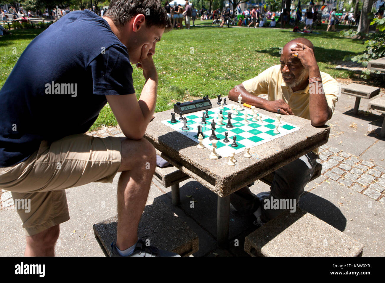Men playing chess outdoors in a park at Dupont Circle - Washington, DC USA Stock Photo