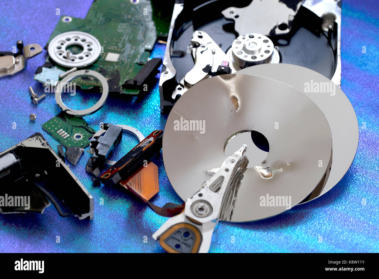 Parts of destroyed computer hard disk drive (HDD exploded view, HDD destroy) - USA Stock Photo