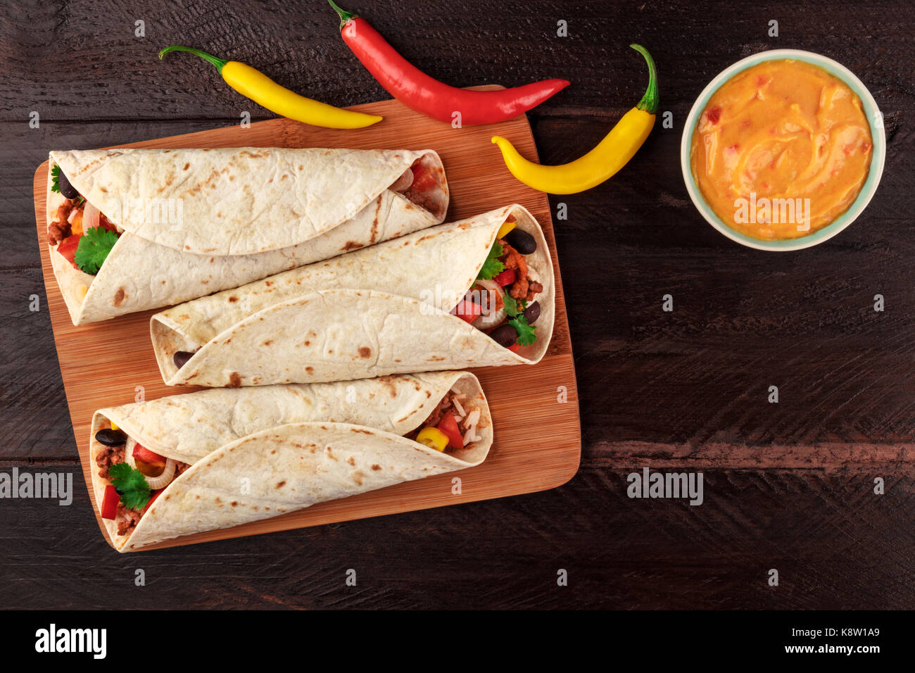 An overhead photo of Mexican burritos with beef, rice, black beans, and