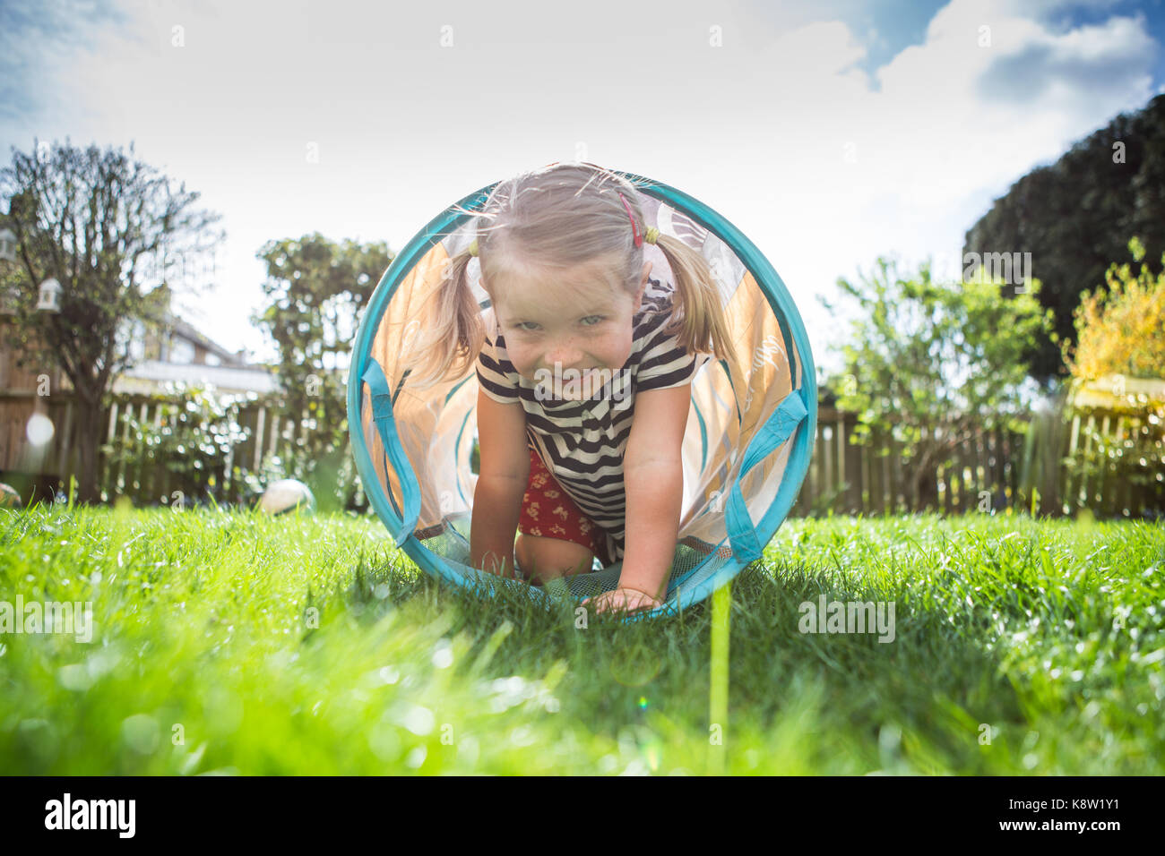 little girl playing in garden Stock Photo