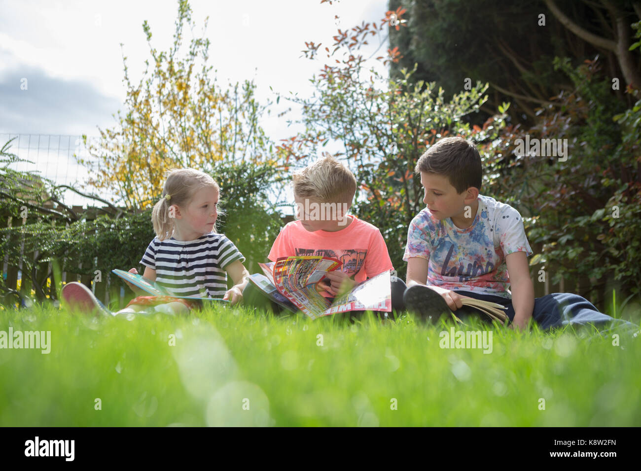 children reading in the garden Stock Photo