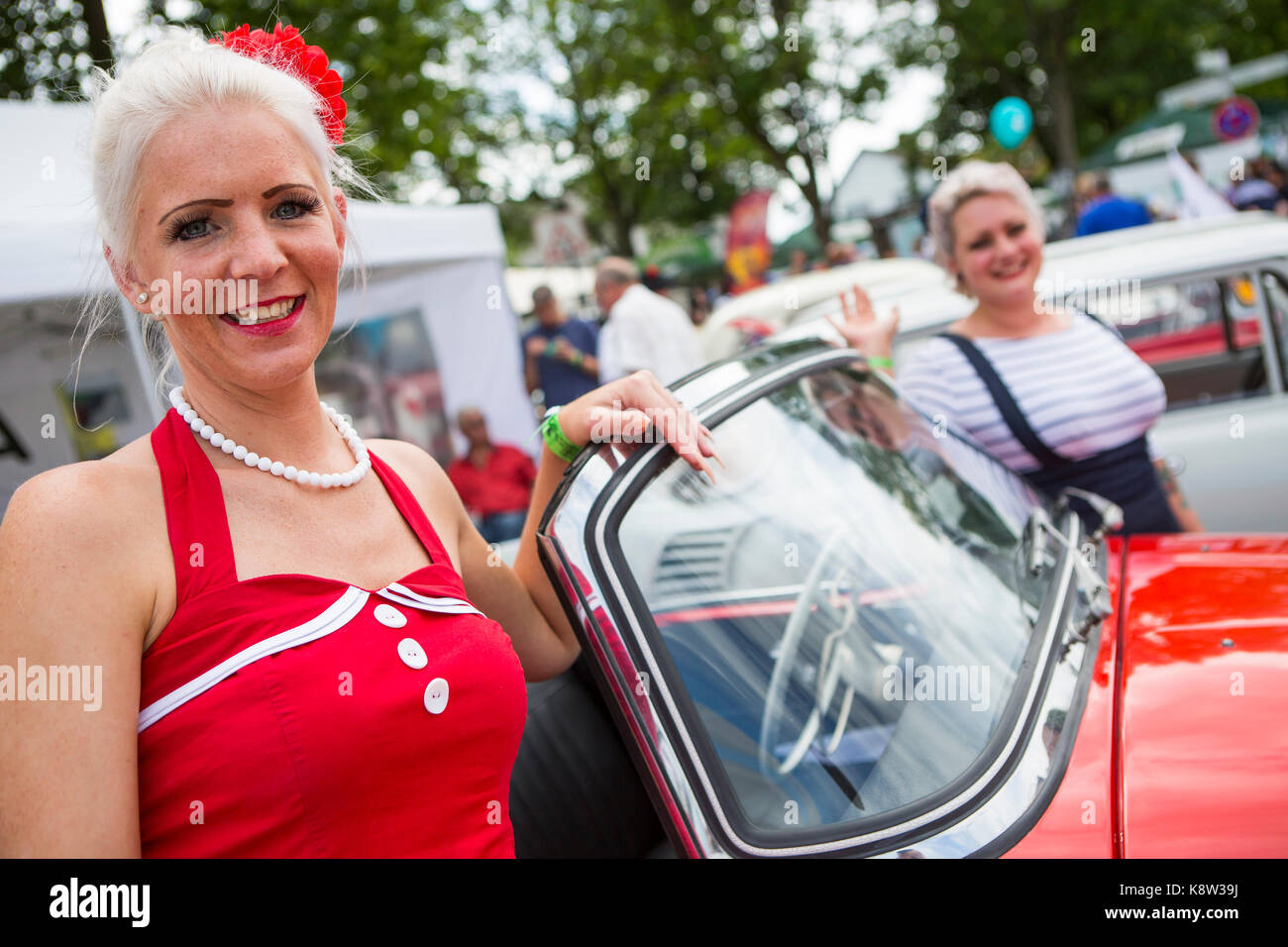 young women in nostalgic outfit in front of classic car Skoda Felicia are visiting Golden Oldies Festival 2017, Wettenberg, Germany. The Golden Oldies Festival is a annual nostalgic festival (est. in 1989) with focus on 1950s to1970s, with over 1000 exhibited classic cars and old-timers, over 50 live bands and nostalgic market. Credit: Christian Lademann Stock Photo