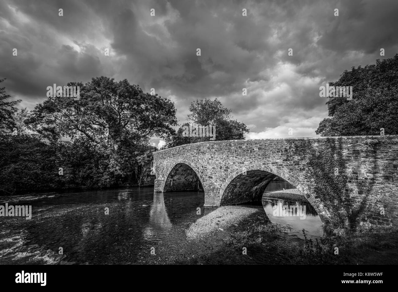 View of the bridge over the River Exe, Exebridge, a village on the border of Devon and Somerset, England at the confluence of the Barle and Exe rivers Stock Photo