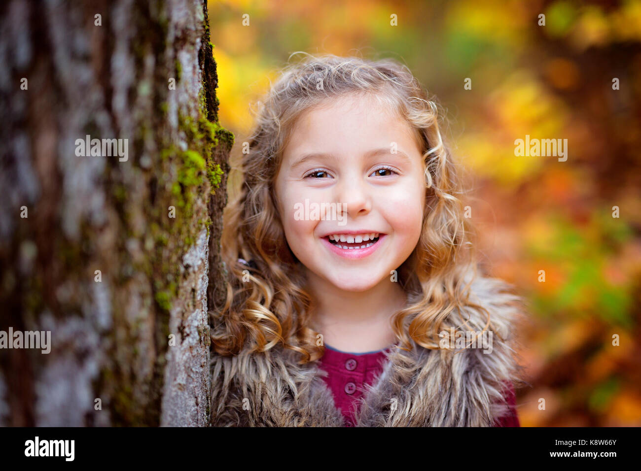 Adorable little girl in a autumn forest Stock Photo - Alamy