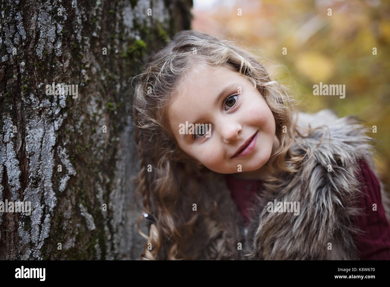 Adorable little girl in a autumn forest Stock Photo - Alamy