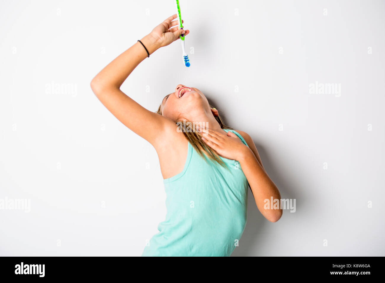 Cute little girl brushing teeth, isolated on white Stock Photo