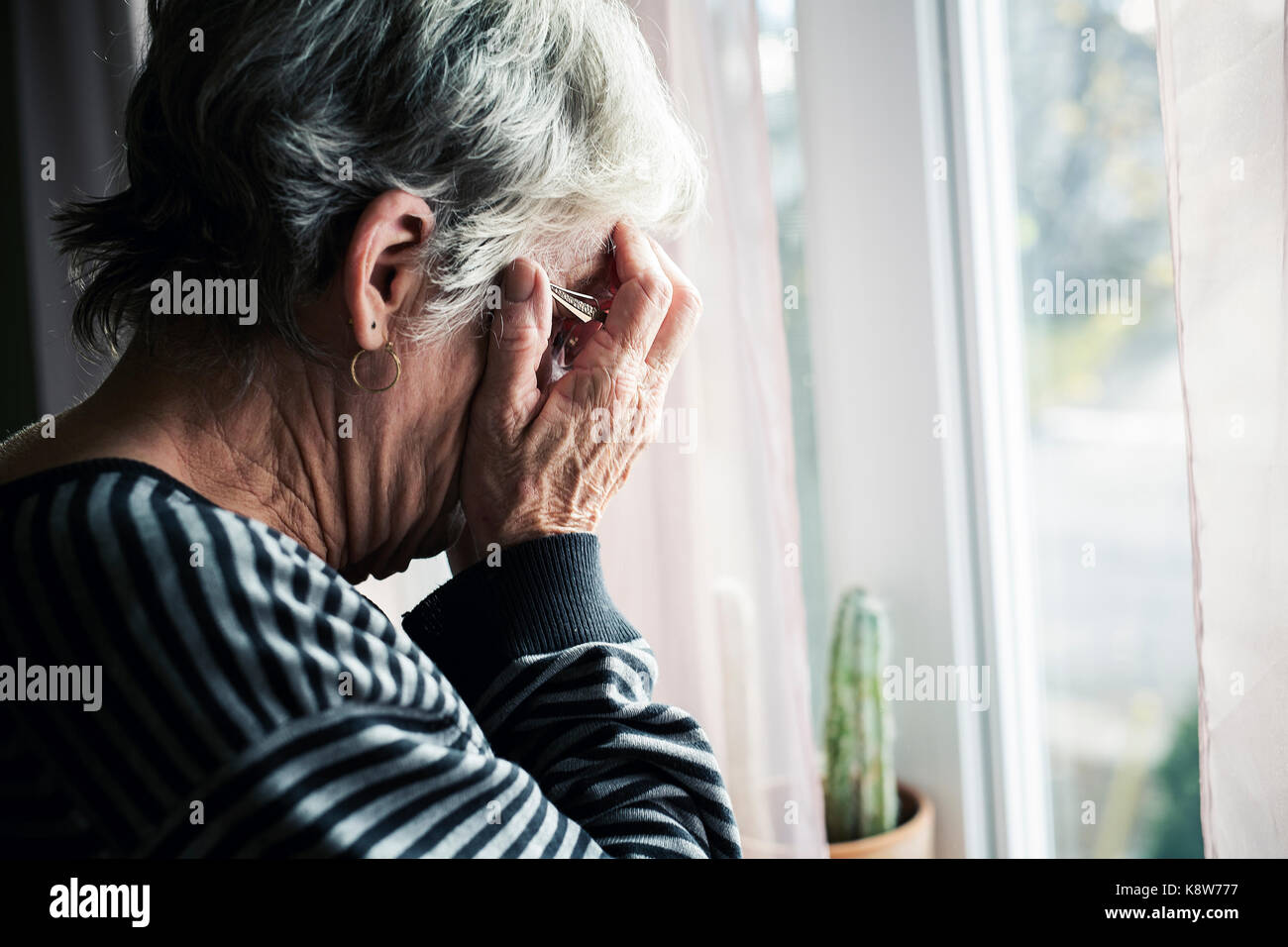 worried senior woman at home felling very bad Stock Photo