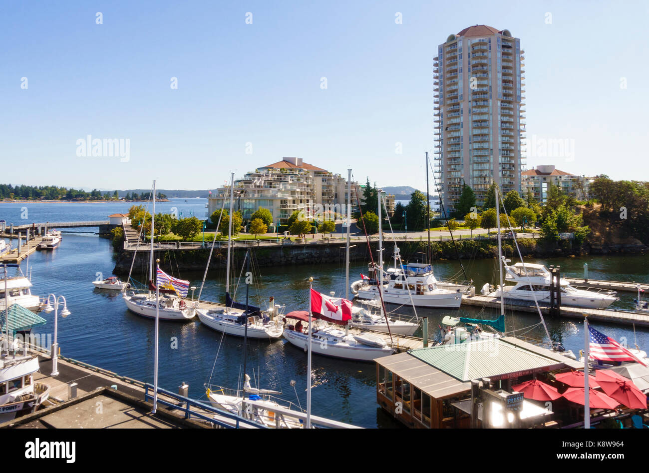 Boats in marina and waterfront apartments condominiums real estate, Nanaimo boat basin, Vancouver Island, British Columbia, Canada Stock Photo