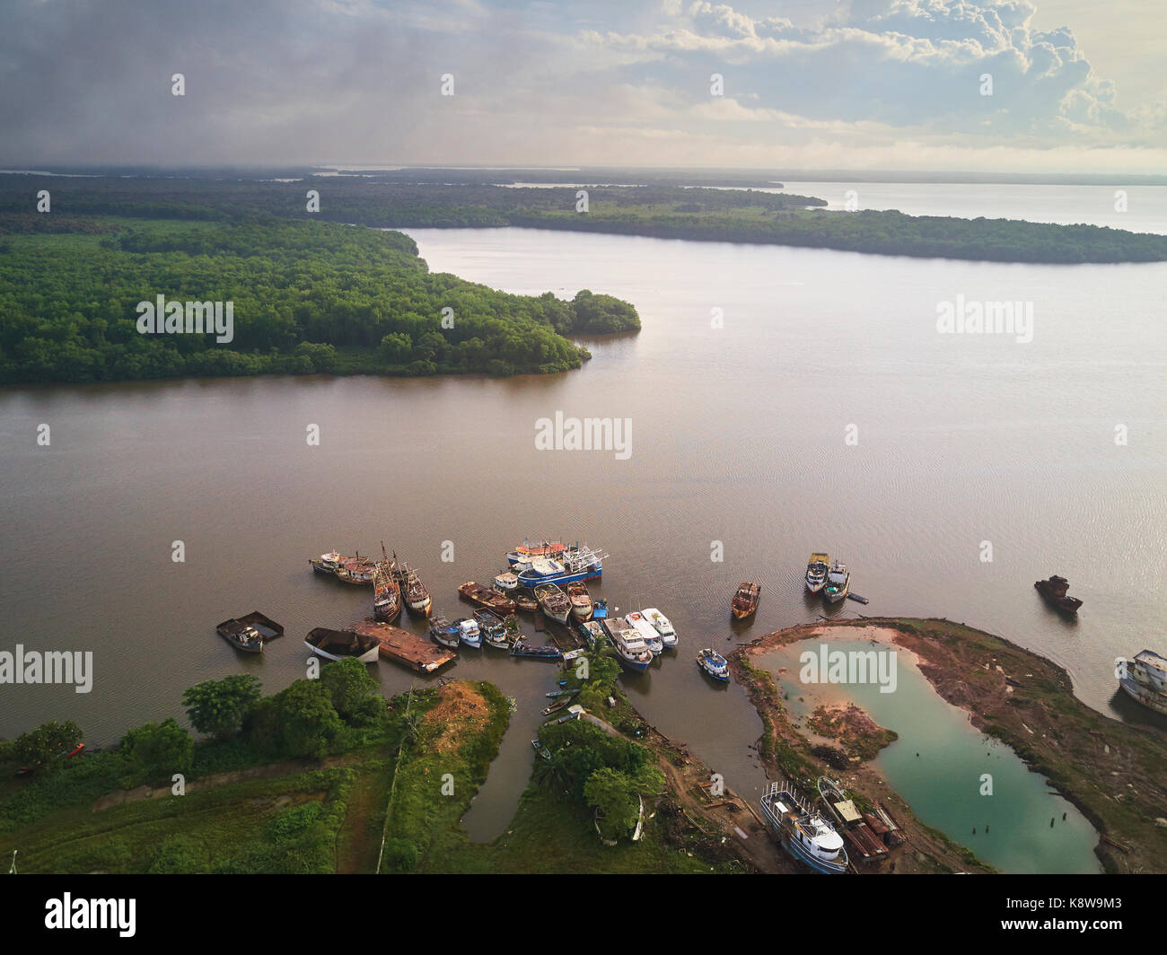 Rusty abondoned ships in river aerial drone view Stock Photo