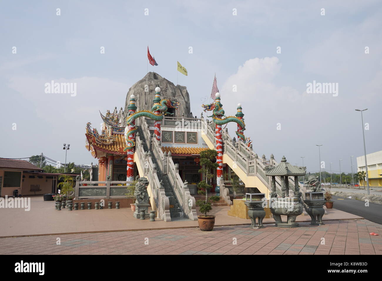 Qi Jian Xian Shi Fo Zu Gu Miao, a Chinese temple in Pasir Penambang, Kuala Selangor, Malaysia. Features a cave-like structure at the top of the temple Stock Photo