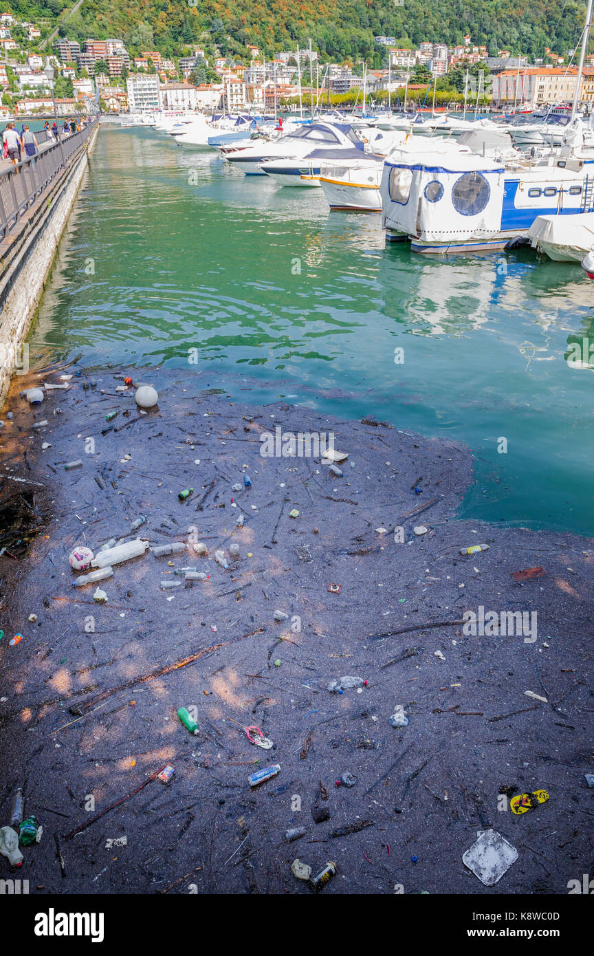 Floating rubbish and trash along side expensive yachts at the Como