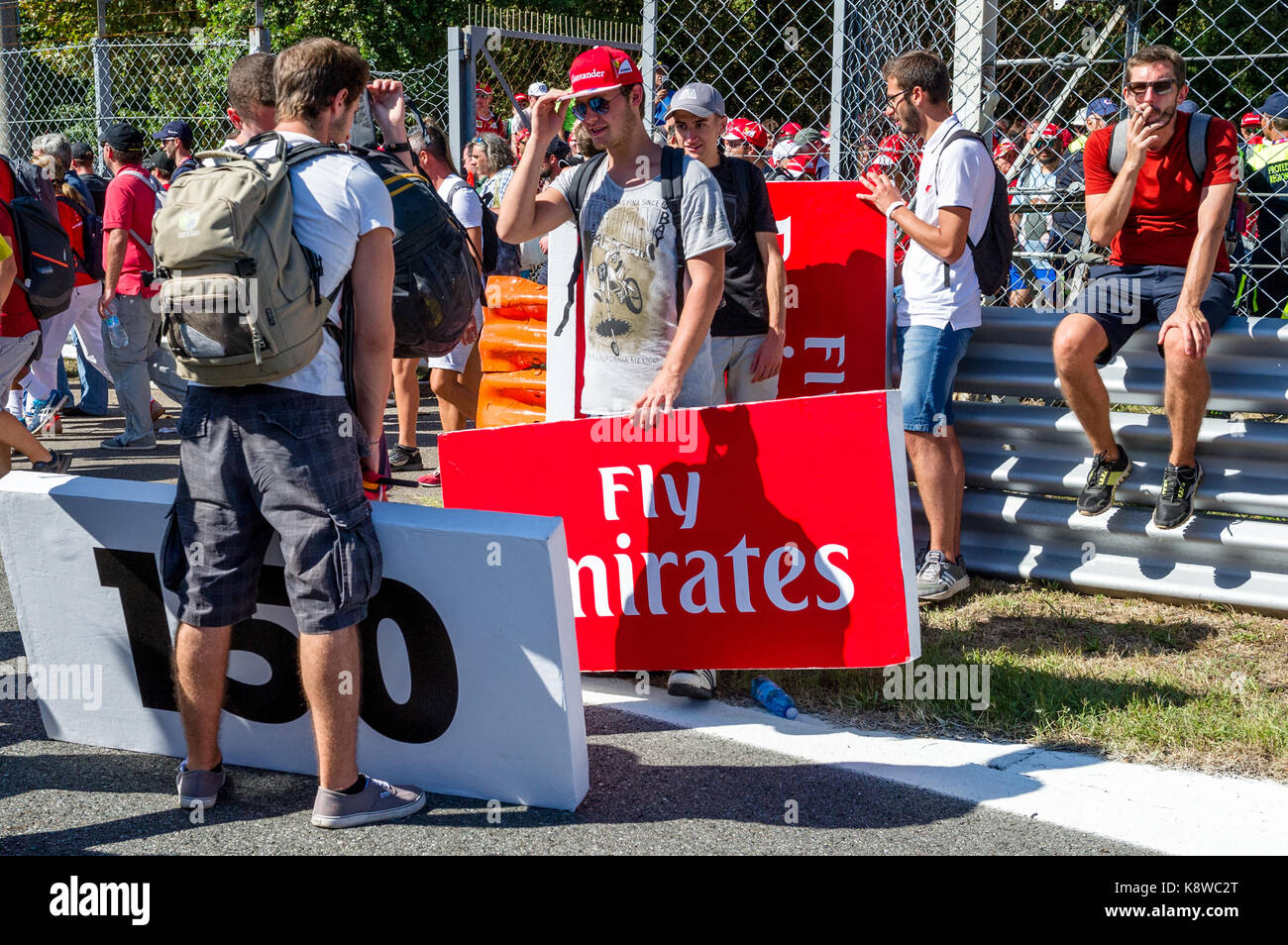 Formula 1 fans and the Italian Tifosi removing track side information and advert boards at the end of the 2017 Italian Grand Prix at Monza. Stock Photo