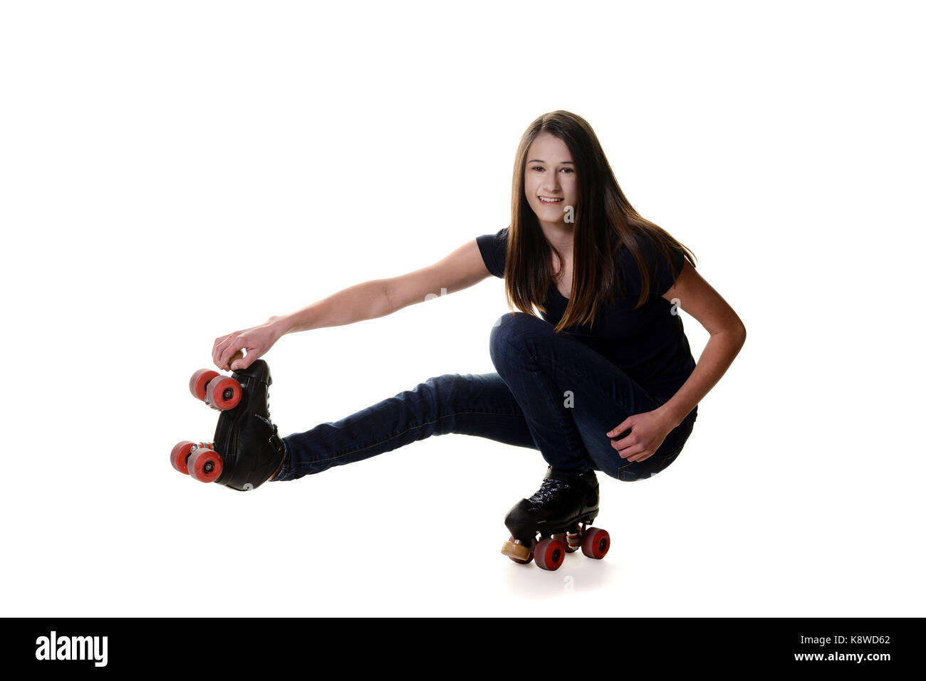 teen girl doing shoot the duck roller skate move Stock Photo Alamy
